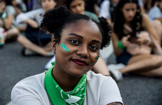 Mujer afro descendiente, con pañuelo verde en el cuello